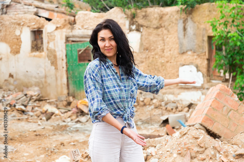 Adult Asian woman is staning among ruins photo