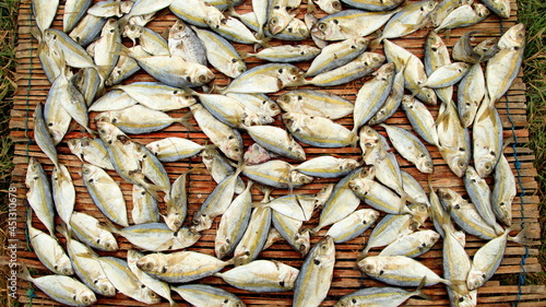 close-up dried fish on bamboo background. Top view. Traditional salted fish drying on racks