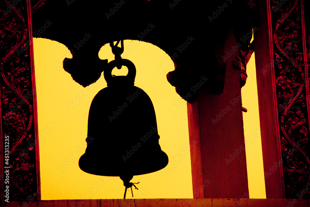 Silhouette of the bell tower in the temple . The bell is used to ring to tell the time.
This photo was taken at Wat Nam Krok, Nan Province. - obrazy, fototapety, plakaty 