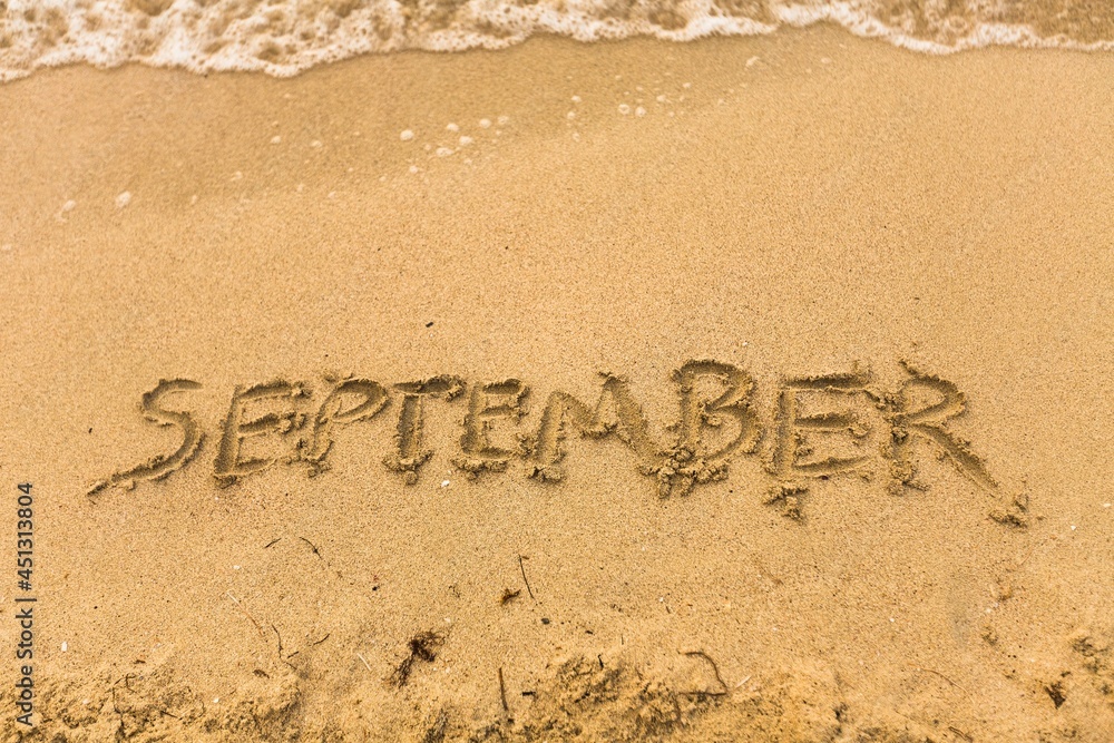 Fototapeta premium Inscription on wet sand september beach.