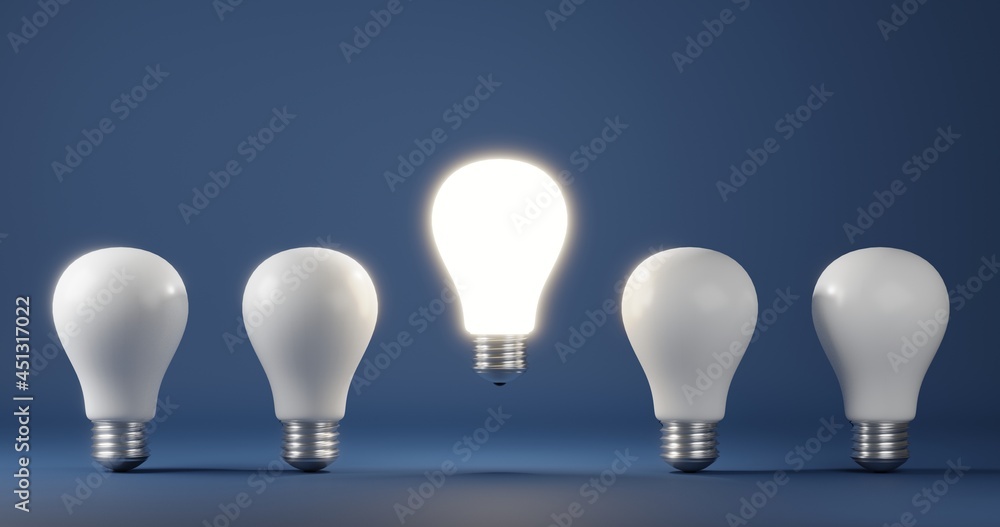 Glowing light bulb on bright between others on dark blue background Glowing light bulb on bright between others on dark blue background