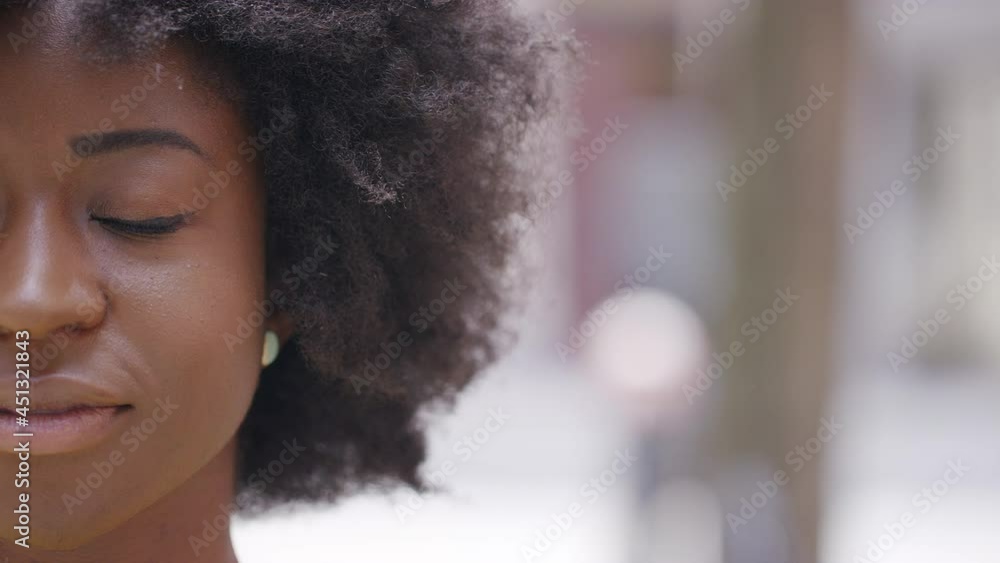Camera pans across the face of a serene young woman standing with her eyes closed, in slow motion Camera pans across the face of a serene young woman standing with her eyes closed, in slow motion
