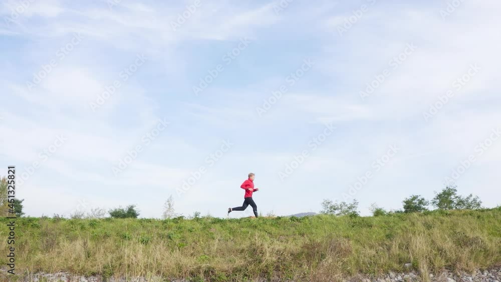 Slow motion athlete running on sunny beautiful cold day during intensive session. Sports concept. Slow motion athlete running on sunny beautiful cold day during intensive session. Sports concept.
