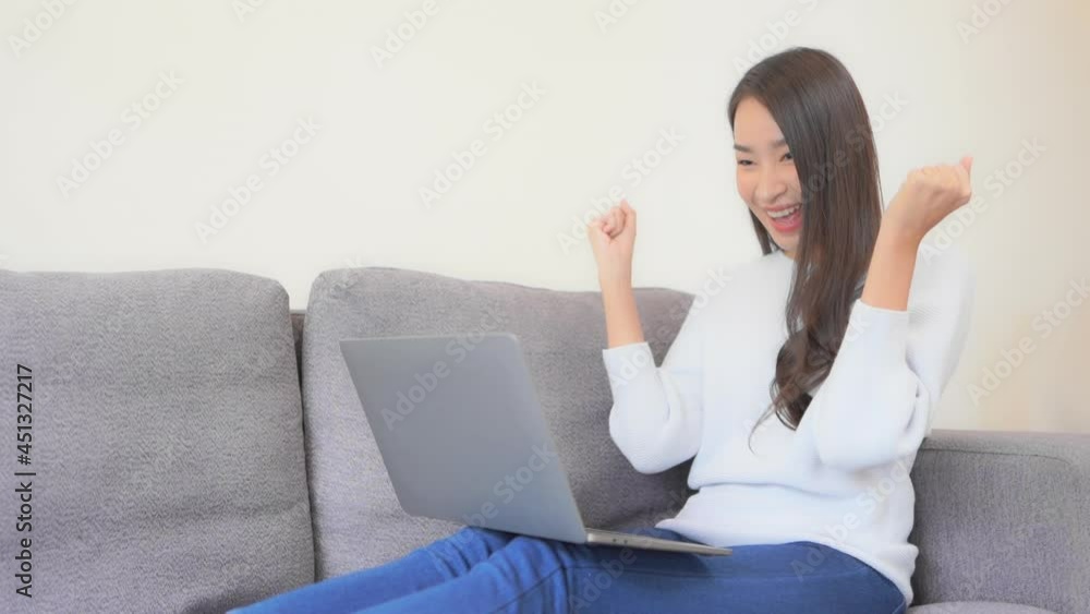 Young Asian Female Typing on Laptop, Celebrating Success With Yes Hand Gesture. Gambling Online or Cryptocurrency Concept, Full Frame Slow Motion Young Asian Female Typing on Laptop, Celebrating Success With Yes Hand Gesture. Gambling Online or Cryptocurrency Concept, Full Frame Slow Motion