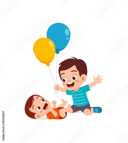 cute little boy play balloon with baby sibling