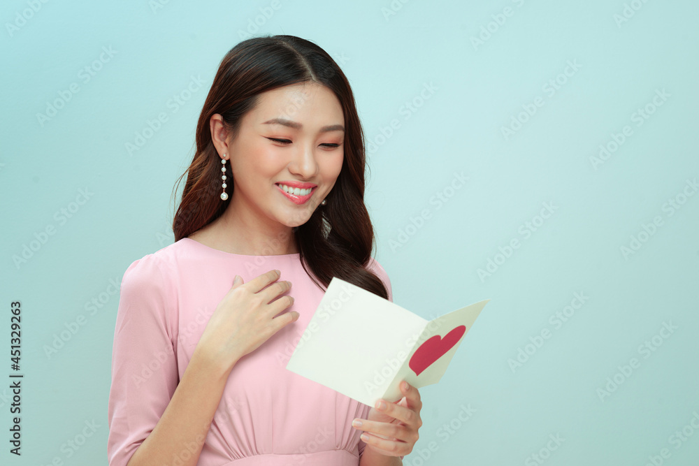 Beautiful asian woman reading a love letter on valentine's day Beautiful asian woman reading a love letter on valentine's day