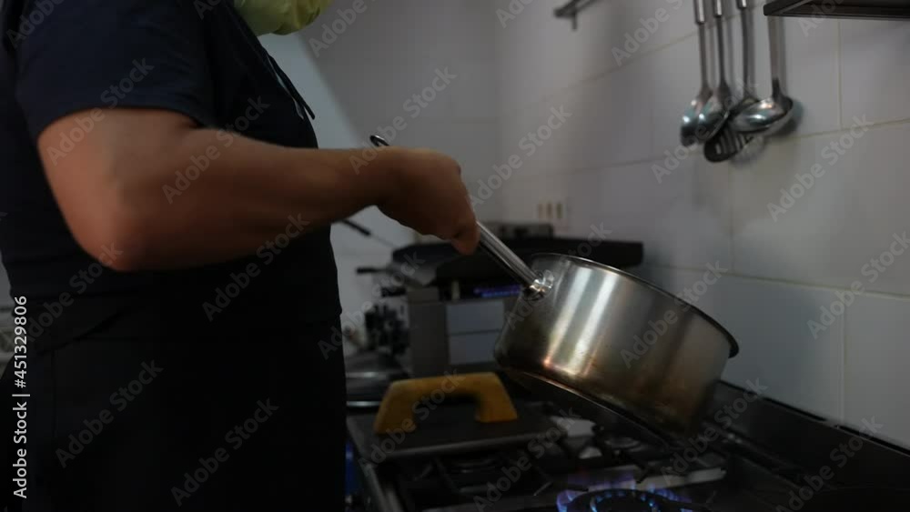 Chef cooking vegetables in frying pan on burning fire slow motion. High quality FullHD footage.Man Cooking Food In Flambe Style At Kitchen.the chef mixes the vegetable in a metal bowl tossing it in. Chef cooking vegetables in frying pan on burning fire slow motion. High quality FullHD footage.Man Cooking Food In Flambe Style At Kitchen.the chef mixes the vegetable in a metal bowl tossing it in.