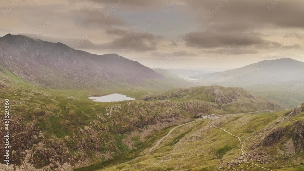 Aerial Cinematic smooth dolly in of Snowdonia National Park Wales from Mount Snowdon filled with drama and atmosphere - Wild, wilderness and adventure concepts - Popular hiking trail for tourists. Aerial Cinematic smooth dolly in of Snowdonia National Park Wales from Mount Snowdon filled with drama and atmosphere - Wild, wilderness and adventure concepts - Popular hiking trail for tourists.