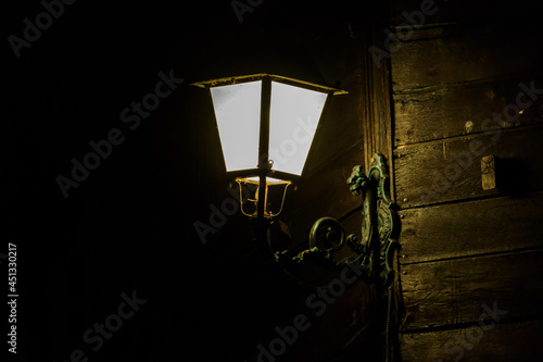 Lighted vintage street lantern at night