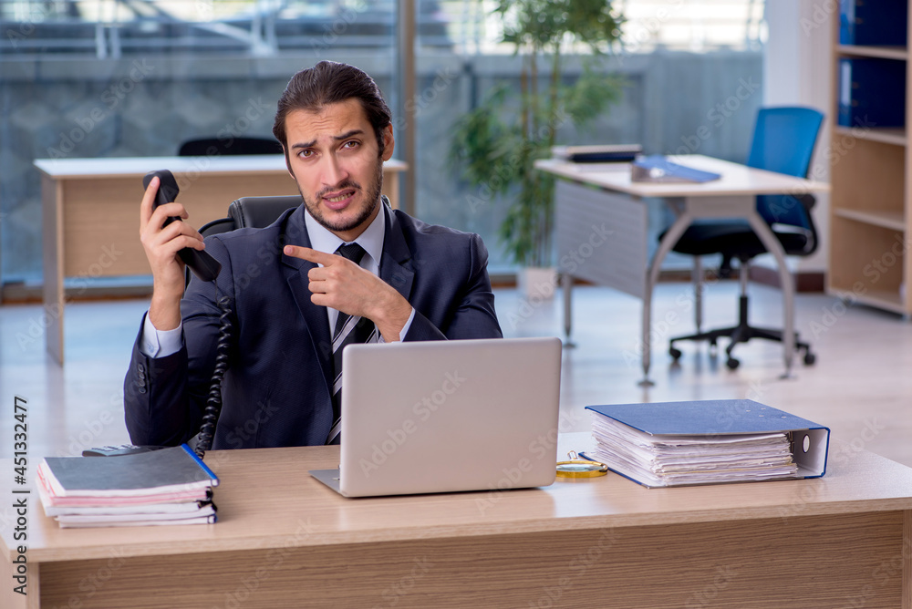 Young businessman employee working in the office Young businessman employee working in the office
