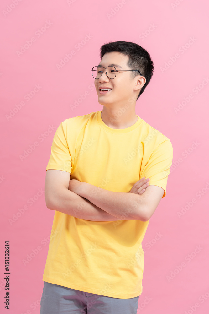 Obraz premium Asian young handsome man in yellow t-shirt smiling on pink background