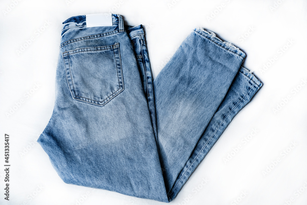 Blue denim jeans on white background. Isolated on white. Blue denim jeans on white background. Isolated on white.