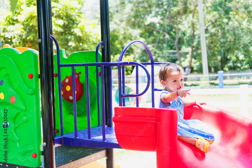 Obraz premium cute little girl laughing happily On the playground in the yellow sunlight happiness,