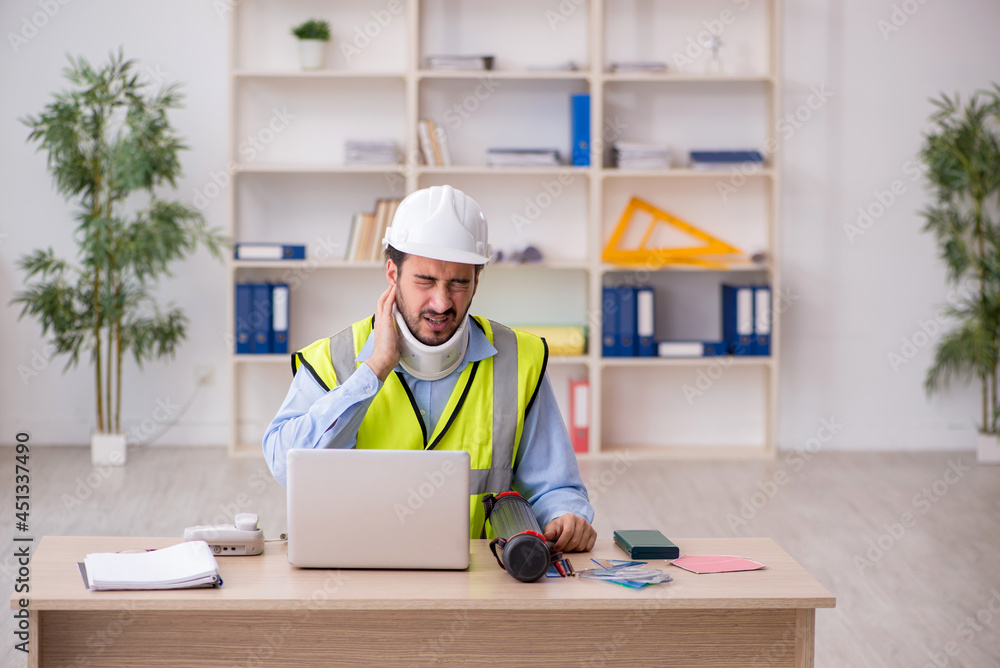 Young neck injured male architect in safety concept Young neck injured male architect in safety concept