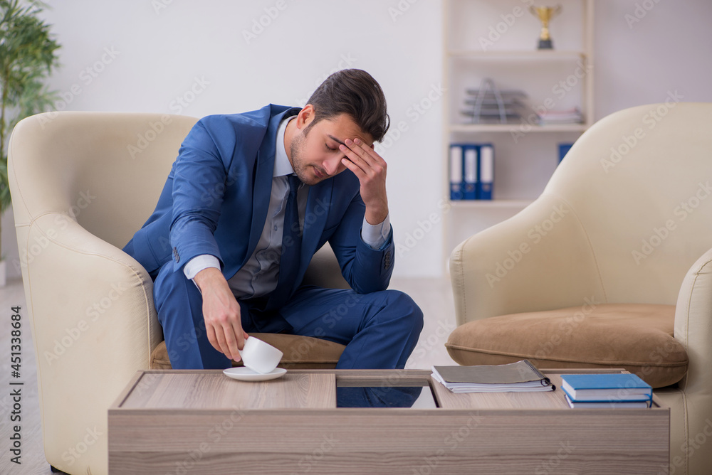 Young male employee waiting for business meeting Young male employee waiting for business meeting