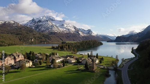 Aerial drone footage of the Sils village and lake in the stunning Engadine valley in the alps in Canton Graubunden (Grisons) in Switzerland photo