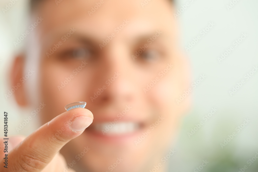 Young man with contact lens, closeup Young man with contact lens, closeup