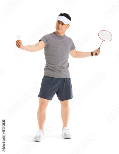 Sporty male badminton player on white background