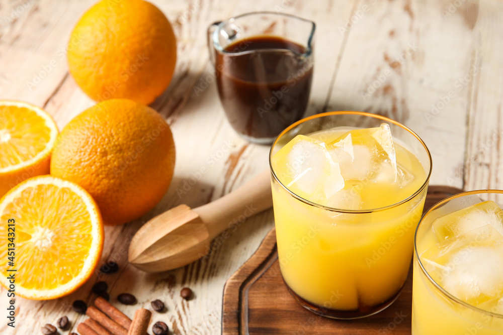 Glasses with cold orange juice and fresh fruits on light wooden background, closeup Glasses with cold orange juice and fresh fruits on light wooden background, closeup