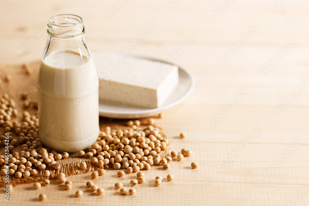 soy milk in a bottle on wooden table soy milk in a bottle on wooden table