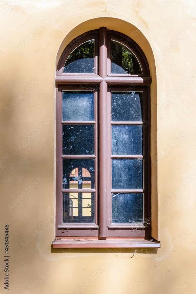 Arched window on a plastered painted wall Arched window on a plastered painted wall