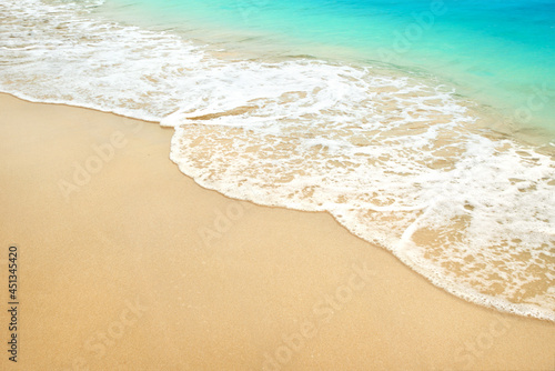 Summer sand beach with ocean waves.
