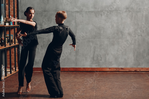 Young couple in black dancing ballroom dance Paso Doble photo