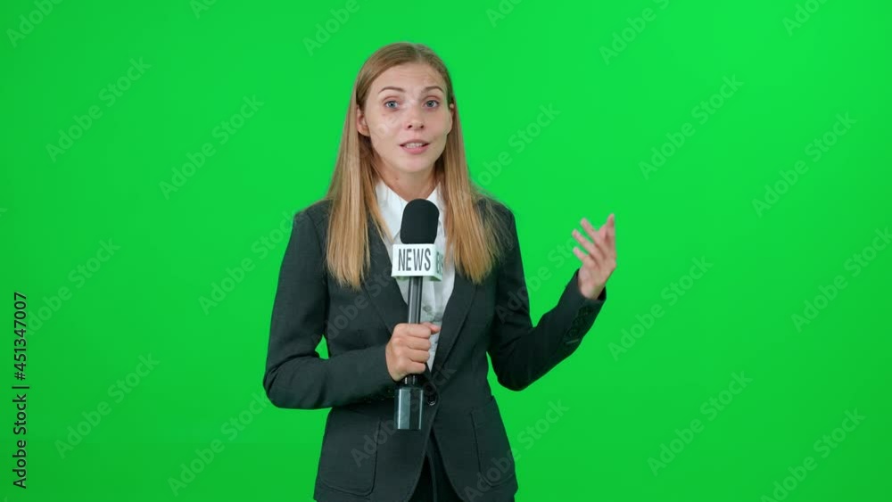 Breaking news, caucasian female news reporter speaks into a microphone on a green background and looks into the camera, template for TV news agencies, woman journalist at work, chromakey. Breaking news, caucasian female news reporter speaks into a microphone on a green background and looks into the camera, template for TV news agencies, woman journalist at work, chromakey.