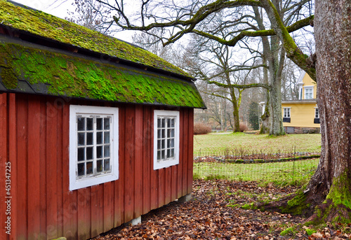 Red old playhouse in the garden photo