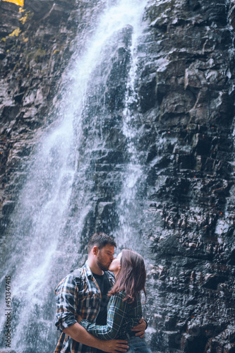 Fototapeta Naklejka Na Ścianę i Meble -  couple in front of waterfall autumn season
