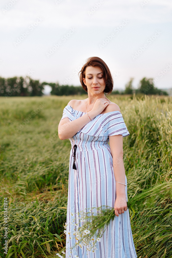Beautiful young woman in summer in a wheat field Beautiful young woman in summer in a wheat field