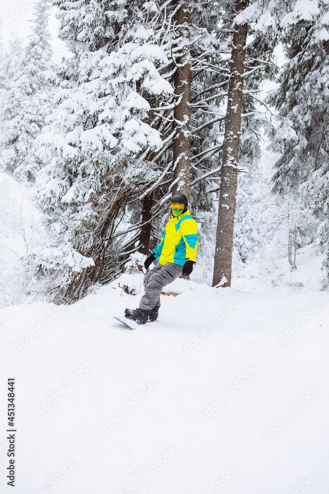 man snowboarder at winter forest