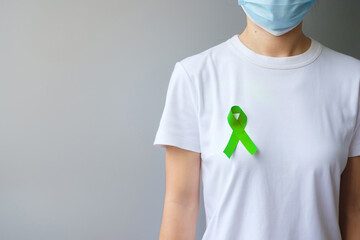 September World lymphoma and October Mental health day Awareness month, Woman with lime green Ribbon color for supporting people living, and illness. Healthcare concepts