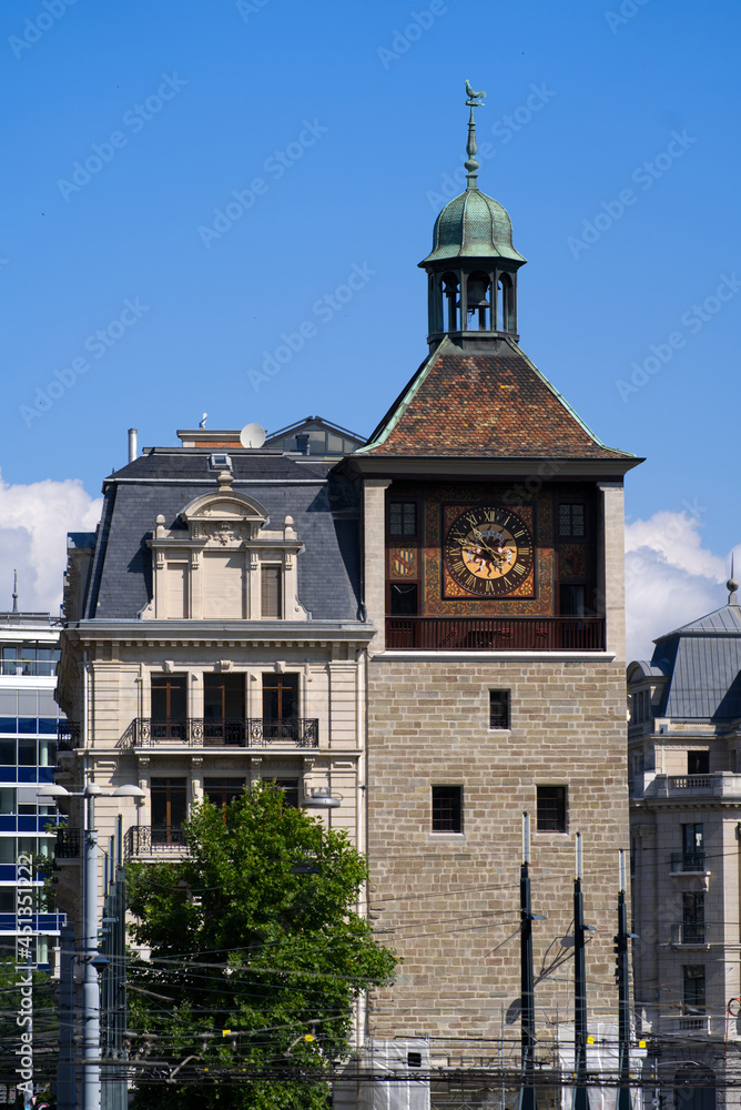 Medieval clock tower at the old town of Geneva on a sunny summer morning. Photo taken July 29th, 2021, Geneva, Switzerland.
