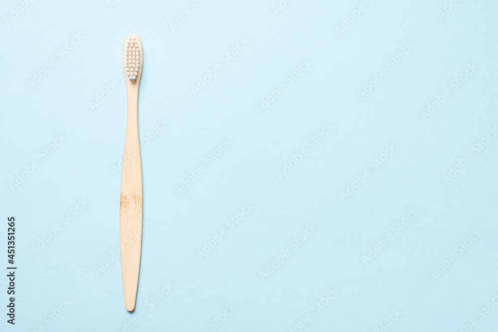 Obraz premium Bamboo toothbrush on a blue background.