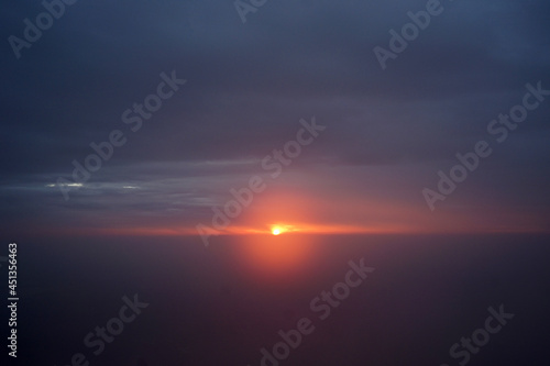 Sunrising at dawn time with foggy and cloudy blue sky © chettarin