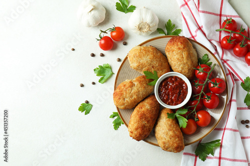 Concept of tasty food with cutlets on white textured table