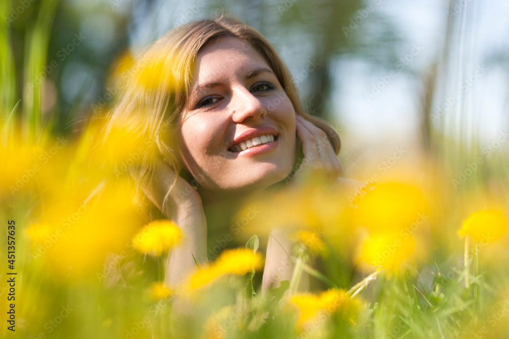 Young Woman Blond Female Summertime Resting on Green Meadow Outdoors With Positive Expression. Young Woman Blond Female Summertime Resting on Green Meadow Outdoors With Positive Expression.