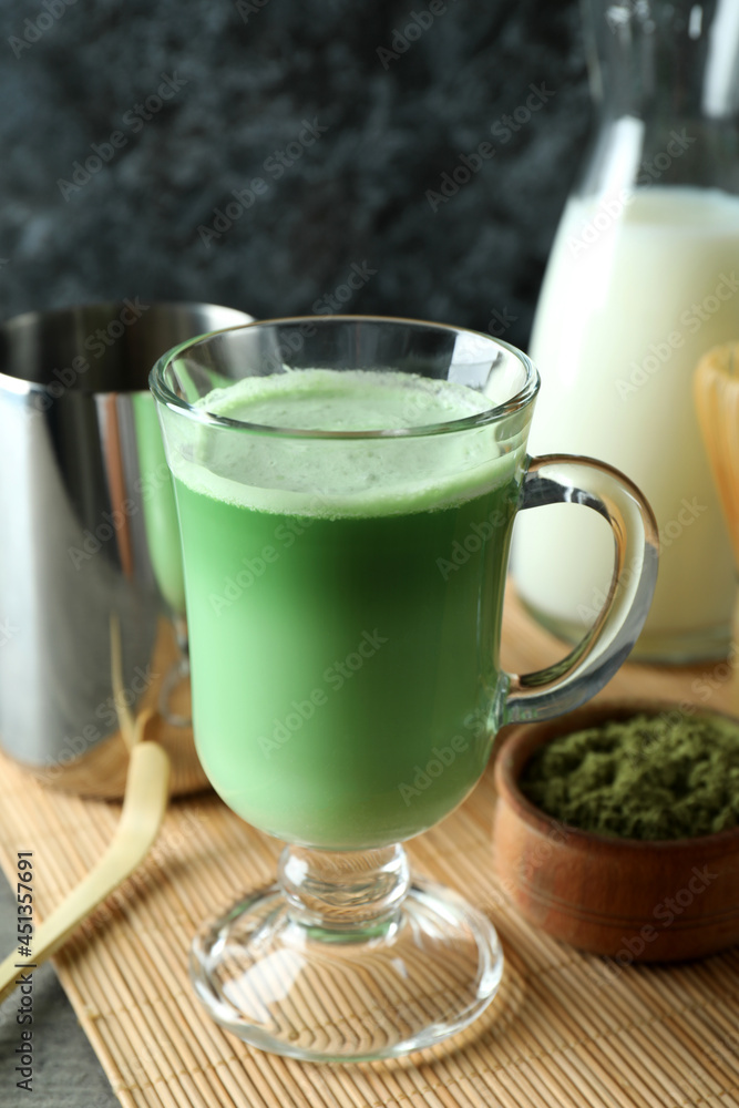 Cup of matcha latte and accessories for making, close up Cup of matcha latte and accessories for making, close up