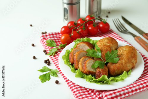 Concept of tasty food with cutlets on white background