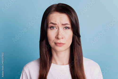 Photo of sad people beautiful girl looking isolated on blue background
