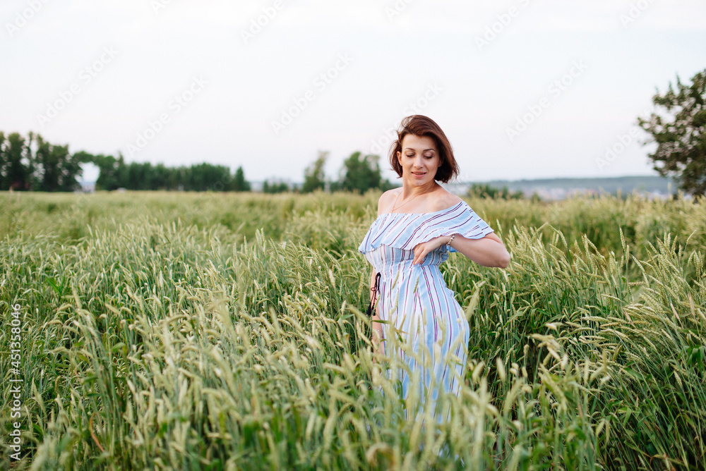 Beautiful young woman in summer in a wheat field Beautiful young woman in summer in a wheat field