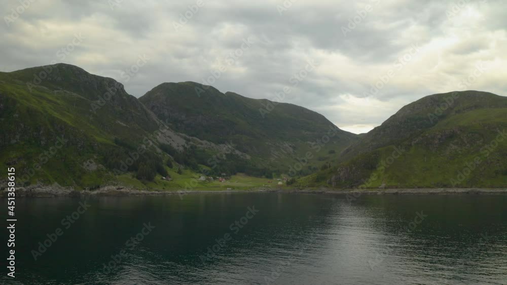 Distant View Of The Green Meadow At The Hillside Of Maaloy Town In Vagsoy Island, Norway. aerial Distant View Of The Green Meadow At The Hillside Of Maaloy Town In Vagsoy Island, Norway. aerial