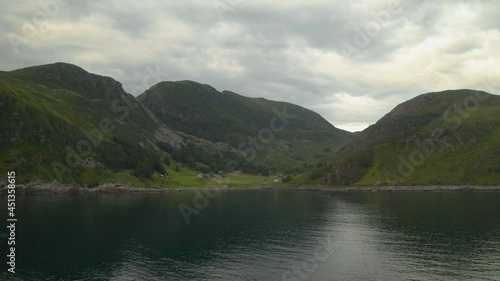 Distant View Of The Green Meadow At The Hillside Of Maaloy Town In Vagsoy Island, Norway. aerial photo