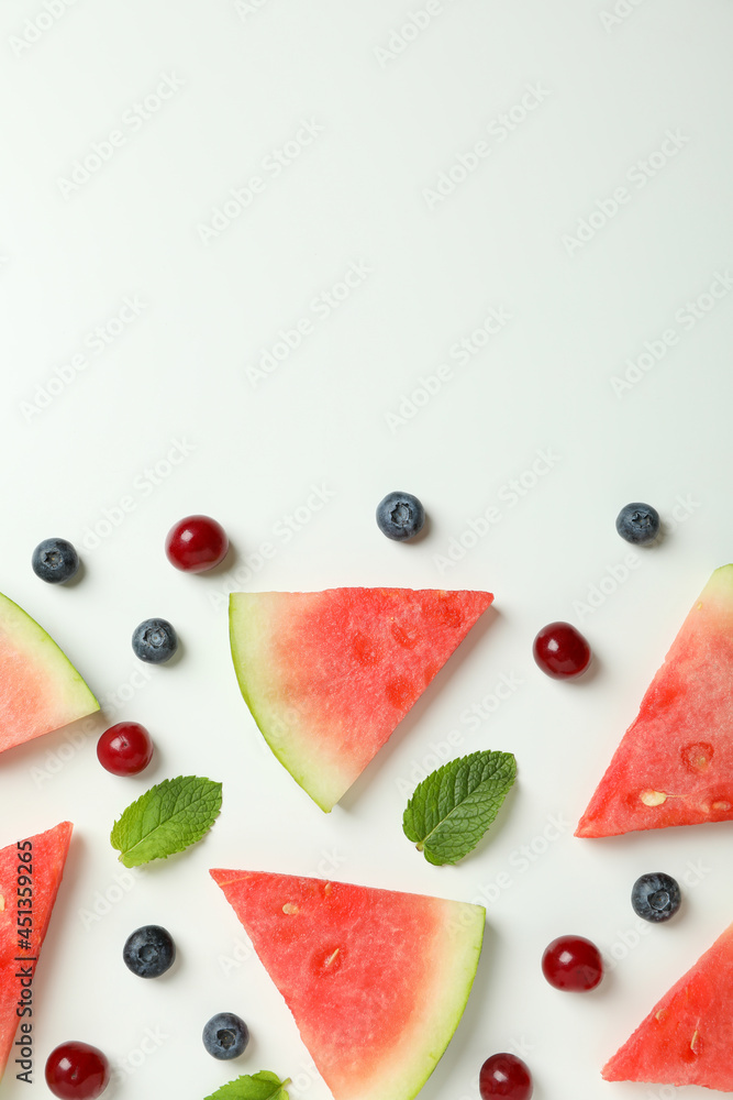 Flat lay with watermelon slices and berries on white background Flat lay with watermelon slices and berries on white background