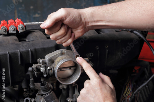 Car service - Engine  repair mechanic hands with wrench © Primastock