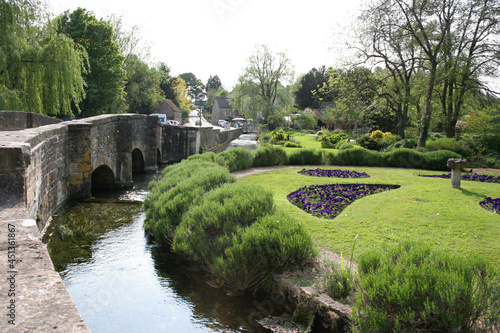 The Gardens of the Swan Hotel and the River Coln in Bibury, Gloucestershire in the UK