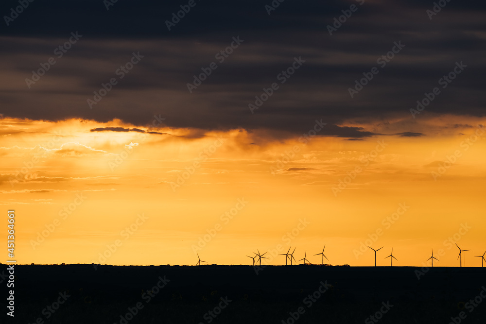 Wind Turbines renewable energy at sunset 