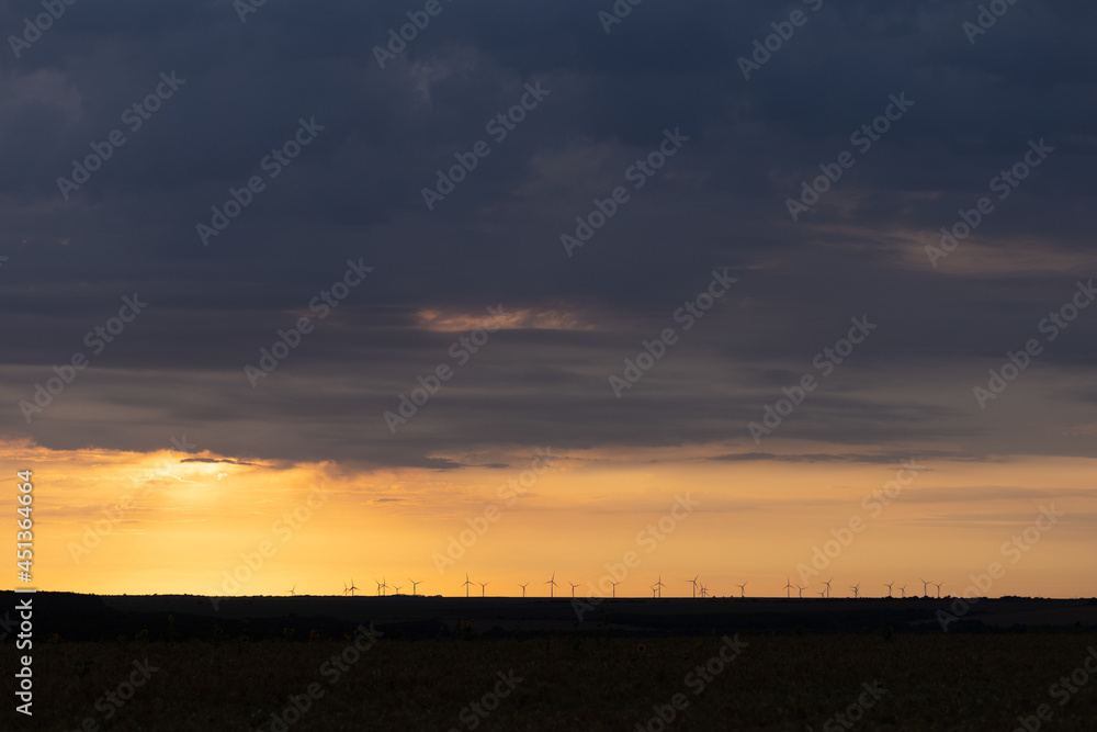 Wind Turbines renewable energy at sunset 