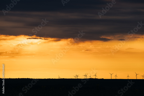 Wind Turbines renewable energy at sunset 